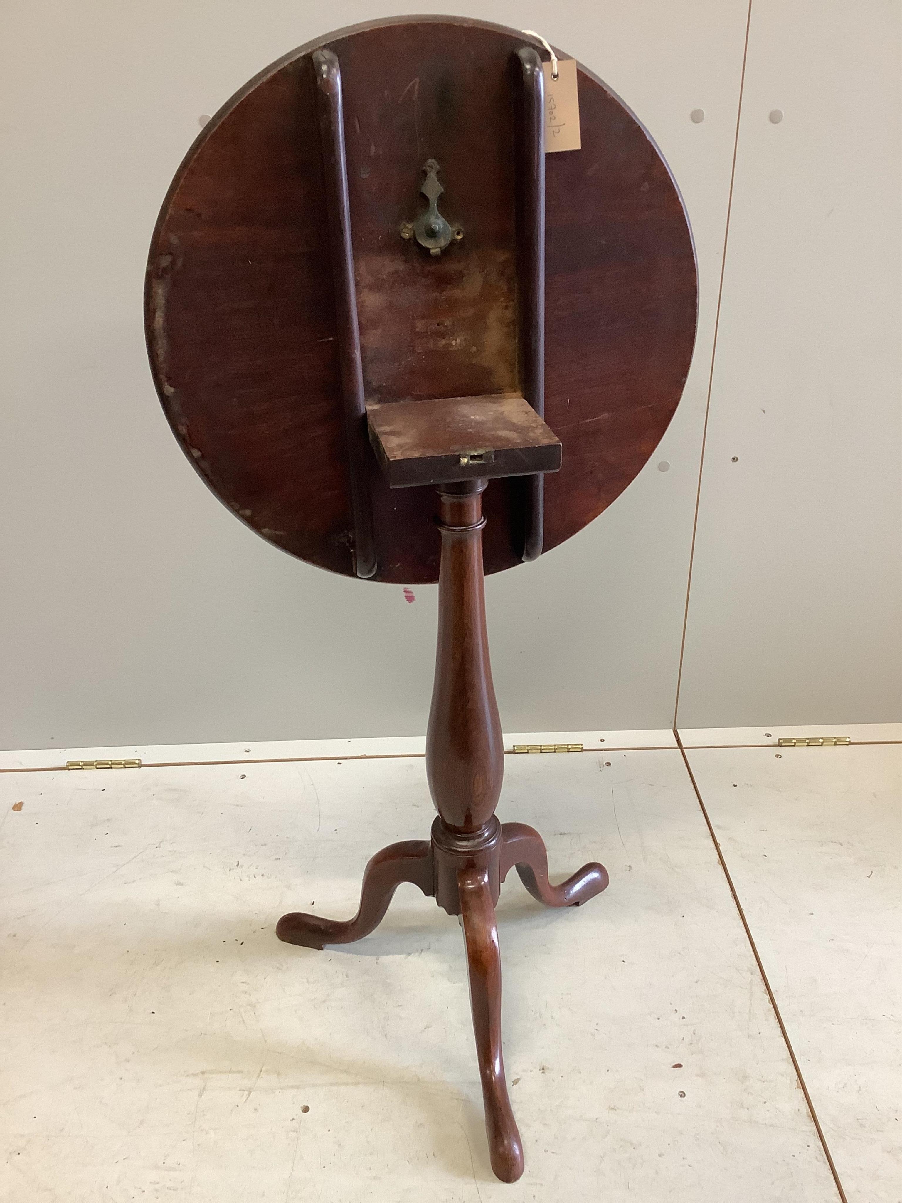 An early Victorian mahogany tilt top tripod wine table, diameter 51cm, height 71cm. Condition - fair